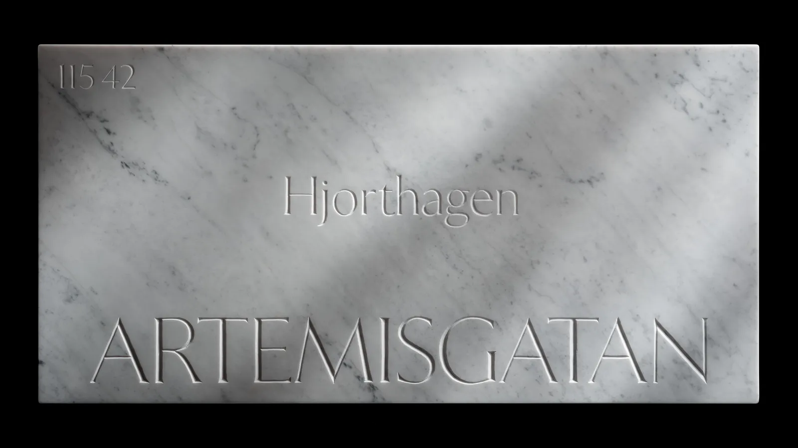 The Artemisgatan marble sign shot straight-on against black, its street name and postal code cut into the stone.